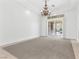 Bright living room with chandelier and sliding glass doors leading to a patio at 379 Turquoise Ct, Boulder City, NV 89005