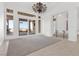 Bright living room featuring sliding doors to a covered patio with mountain views and elegant light fixture at 379 Turquoise Ct, Boulder City, NV 89005