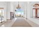 Bright and airy living room with a large window offering scenic views, a fireplace, and a chandelier at 379 Turquoise Ct, Boulder City, NV 89005