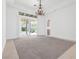 Bright living room with chandelier and sliding glass doors leading to a patio at 379 Turquoise Ct, Boulder City, NV 89005