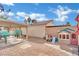 Backyard featuring a playhouse, shade structure, seating and low-maintenance landscaping at 3916 Rhine Way, Las Vegas, NV 89108