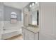 Bright bathroom featuring a tub, vanity, and modern fixtures at 3916 Rhine Way, Las Vegas, NV 89108