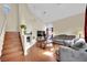 Bright living room featuring high ceilings, a fireplace, and wood floors at 3916 Rhine Way, Las Vegas, NV 89108