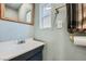 Powder room featuring modern faucet, wood framed mirror, and fresh paint at 4075 E Oquendo Rd, Las Vegas, NV 89120