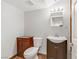 Small bathroom with a dark wood vanity, white sink, and a toilet at 4075 E Oquendo Rd, Las Vegas, NV 89120