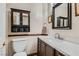 This is a bathroom with a modern vanity, framed mirror, and dark wood accents at 4075 E Oquendo Rd, Las Vegas, NV 89120