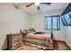 Cozy bedroom features a wooden ceiling fan, wood-look flooring, a window, and a decorative bedspread at 4075 E Oquendo Rd, Las Vegas, NV 89120