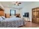 Comfortable bedroom features a ceiling fan, built-in cabinets, and a window for natural light at 4075 E Oquendo Rd, Las Vegas, NV 89120