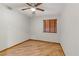 Simple bedroom with wood blinds, ceiling fan, and wood-look tile flooring at 4075 E Oquendo Rd, Las Vegas, NV 89120