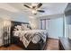 Bedroom features a ceiling fan, wood flooring, and a large window at 4075 E Oquendo Rd, Las Vegas, NV 89120