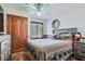 This bedroom features a wood accent wall, complementing the wood-look flooring and rustic decor at 4075 E Oquendo Rd, Las Vegas, NV 89120