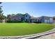 Two-story home with a well-maintained front lawn and a brick chimney on the left side of the building at 4075 E Oquendo Rd, Las Vegas, NV 89120