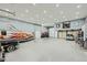 Expansive garage with multiple vehicles, workshop area, and abundant natural light at 4075 E Oquendo Rd, Las Vegas, NV 89120