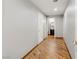 Bright hallway with wood-look tile flooring leading to a bathroom at 4075 E Oquendo Rd, Las Vegas, NV 89120