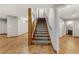 Hallway with wood-look floors and carpeted stairs with wood railing at 4075 E Oquendo Rd, Las Vegas, NV 89120