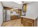 A kitchen with stainless steel appliances, granite countertops, and wooden cabinets at 4075 E Oquendo Rd, Las Vegas, NV 89120