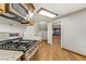 Modern kitchen with stainless steel appliances and granite countertops, and wood-look tile flooring at 4075 E Oquendo Rd, Las Vegas, NV 89120