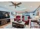 This living room features a ceiling fan and a TV. It's a perfect space for relaxation at 4075 E Oquendo Rd, Las Vegas, NV 89120