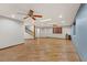 Spacious living room with ceiling fans, wood blinds, staircase and wood-look tile flooring at 4075 E Oquendo Rd, Las Vegas, NV 89120