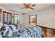 Cozy main bedroom with natural light, wood floors, and ceiling fan at 4075 E Oquendo Rd, Las Vegas, NV 89120