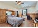 Large main bedroom with wood floors, ceiling fan, and built in storage units at 4075 E Oquendo Rd, Las Vegas, NV 89120