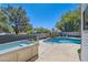 Backyard featuring a refreshing pool, hot tub, and lounging area, perfect for outdoor relaxation at 4075 E Oquendo Rd, Las Vegas, NV 89120