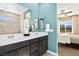 Bathroom with double sinks, large mirrors, and a view to the bedroom at 4220 E Brusca Way, Pahrump, NV 89061