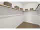 Walk-in closet with a wooden rod and built-in shelving, providing ample storage space at 4220 E Brusca Way, Pahrump, NV 89061