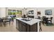 Modern kitchen island with bar seating that opens to a large living and dining area with lots of seating options at 4220 E Brusca Way, Pahrump, NV 89061