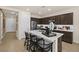 Modern kitchen with a large white countertop island, dark cabinets, stainless steel appliances, and pendant lighting at 4220 E Brusca Way, Pahrump, NV 89061