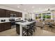 Spacious kitchen and living area featuring modern stainless appliances and bar stool seating at the kitchen island at 4220 E Brusca Way, Pahrump, NV 89061