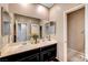 Bright bathroom featuring double vanity, large mirror, and neutral tones at 4566 Ganier Ct # 1125, North Las Vegas, NV 89031