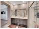 Stylish bathroom with double sinks, a large mirror, and a glass-enclosed shower creating a luxurious space at 4566 Ganier Ct # 1125, North Las Vegas, NV 89031