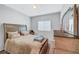 Neutral bedroom featuring a large bed, dresser, and window with natural light at 4566 Ganier Ct # 1125, North Las Vegas, NV 89031