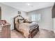 Spacious bedroom featuring a beautifully carved wooden bed frame with comfy pillows and lots of natural light at 4566 Ganier Ct # 1125, North Las Vegas, NV 89031