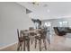 Bright dining room featuring tile flooring, staircase, recessed lighting, and a metal table with black chairs at 4566 Ganier Ct # 1125, North Las Vegas, NV 89031