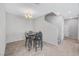 Bright dining room featuring tile flooring, staircase, recessed lighting, and a metal table with black chairs at 4566 Ganier Ct # 1125, North Las Vegas, NV 89031