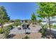 Outdoor grill area featuring stone benches, a stainless steel grill, and manicured landscaping at 4566 Ganier Ct # 1125, North Las Vegas, NV 89031