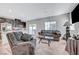 Bright open concept living area with dark cabinets in the kitchen, a comfortable sofa and arm chair at 4566 Ganier Ct # 1125, North Las Vegas, NV 89031