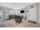 Comfortable living room featuring neutral paint, tile floors, a sliding glass door to the backyard, and modern furnishings at 4566 Ganier Ct # 1125, North Las Vegas, NV 89031