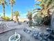 Private backyard retreat showcasing mature palm trees and rock features with meticulous gravel landscaping at 470 Como Ct, Henderson, NV 89015