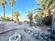 Private backyard retreat showcasing mature palm trees and rock features with meticulous gravel landscaping at 470 Como Ct, Henderson, NV 89015