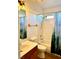 Bathroom vanity with mountain-themed shower curtain and modern lighting at 470 Como Ct, Henderson, NV 89015