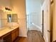 Well-lit primary bathroom with double vanity and separate shower at 470 Como Ct, Henderson, NV 89015