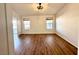 This bedroom features hardwood floors, two windows, and a modern ceiling fan at 470 Como Ct, Henderson, NV 89015