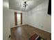 Bedroom featuring wood-look floors, window with wood slat blinds and a ceiling fan at 470 Como Ct, Henderson, NV 89015