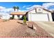 Attractive single-story home with a well-maintained exterior, featuring a large garage and desert landscaping at 470 Como Ct, Henderson, NV 89015