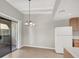 View of dining area with hanging chandelier, sliding door, and adjacent kitchen at 4722 Obannon Dr # D, Las Vegas, NV 89102