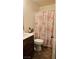 Bathroom with a toilet, sink, vanity and floral shower curtain at 4928 Indigo Gorge Ave, Las Vegas, NV 89131