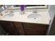 Bathroom with a double sink vanity and dark wood cabinets at 4928 Indigo Gorge Ave, Las Vegas, NV 89131